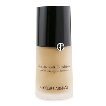 Luminous Silk Foundation by Giorgio Armani in a sleek glass bottle with a black cap, featuring a gold logo and a light beige liquid inside.