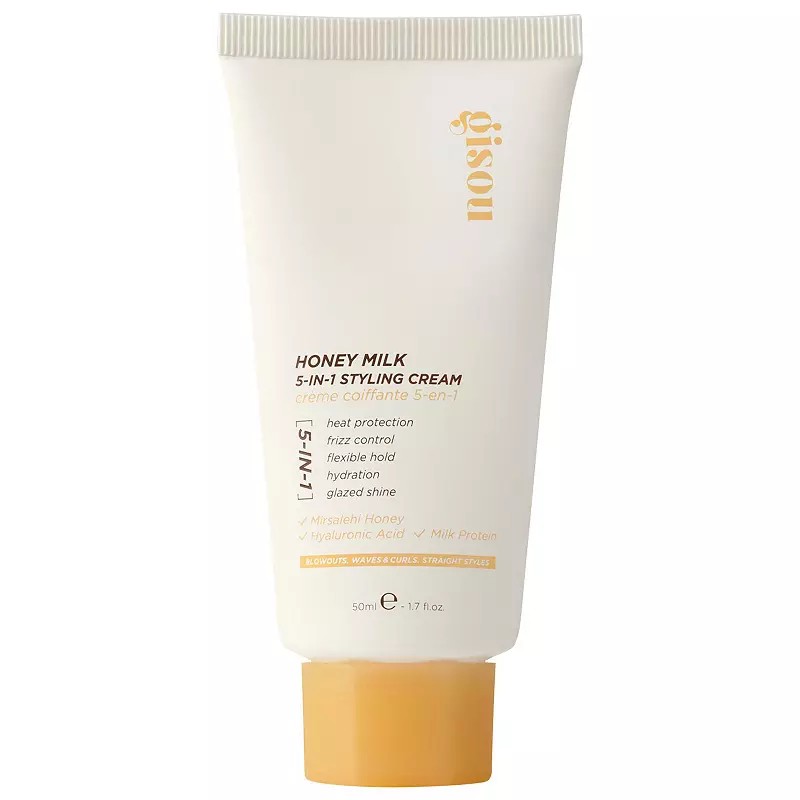 White tube with a gold and yellow label, featuring "Gisou" branding and "Honey Milk 5-in-1 Styling Cream" text, showcasing its 50ml size and key benefits.