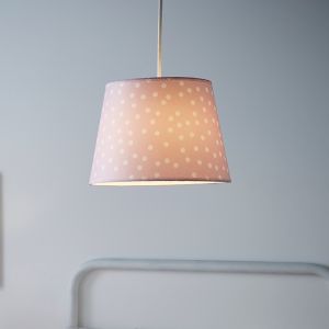 Pink fabric light shade with white polka dots, featuring a tapered design and a soft glow, suspended from a white cord, ideal for adding a playful touch to any room.
