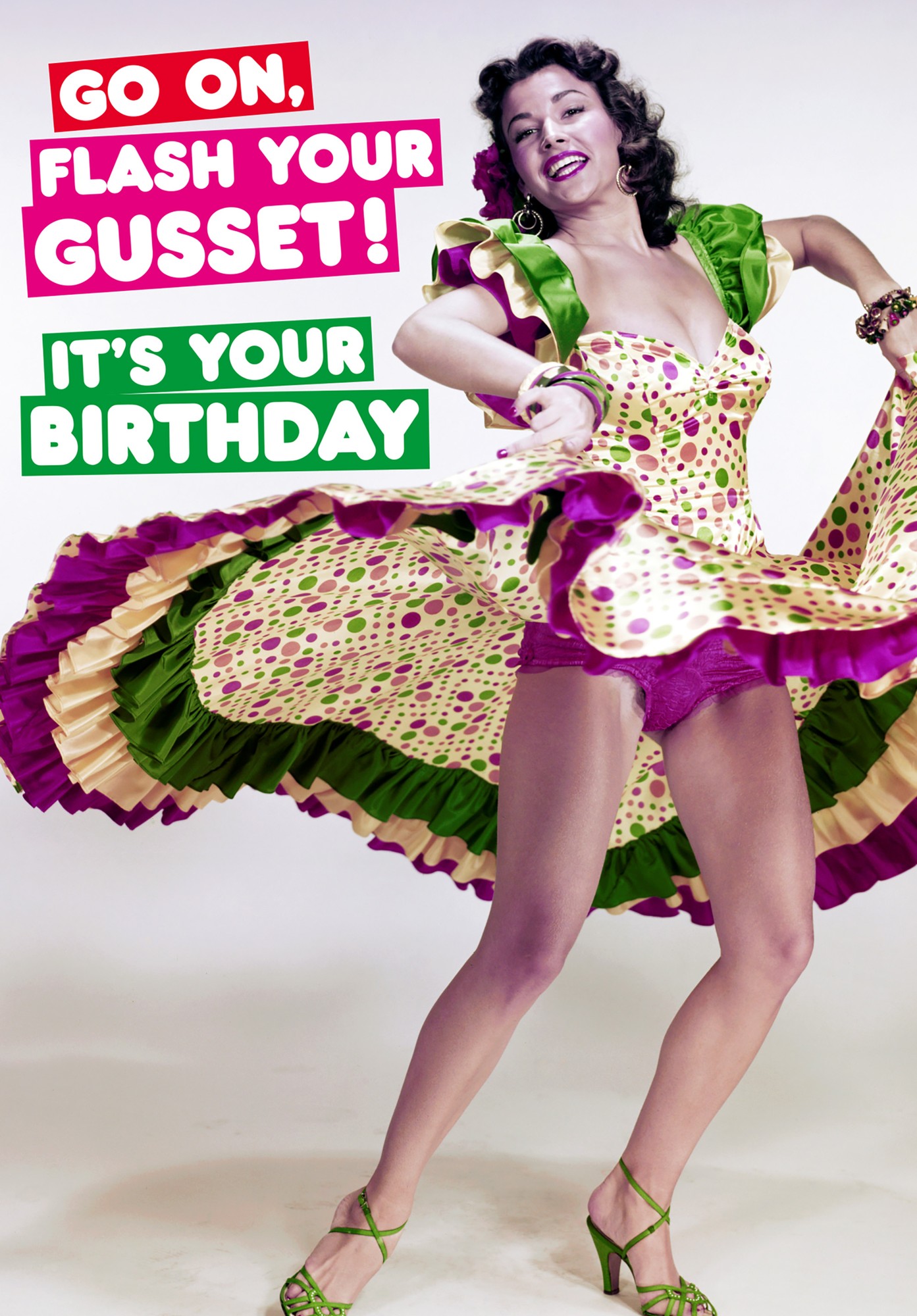 A vibrant birthday card featuring a woman in a colorful polka dot dress with ruffled sleeves, dancing joyfully, with bold text reading "Go on, Flash Your Gusset! It's Your Birthday."