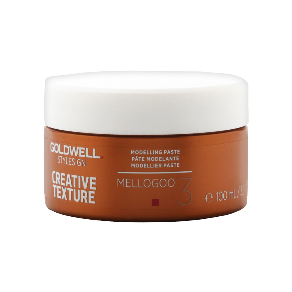 Goldwell StyleSign Creative Texture Mellogoo Modelling Paste in a 100ml brown jar with a white lid, featuring red and white text indicating its purpose and brand.
