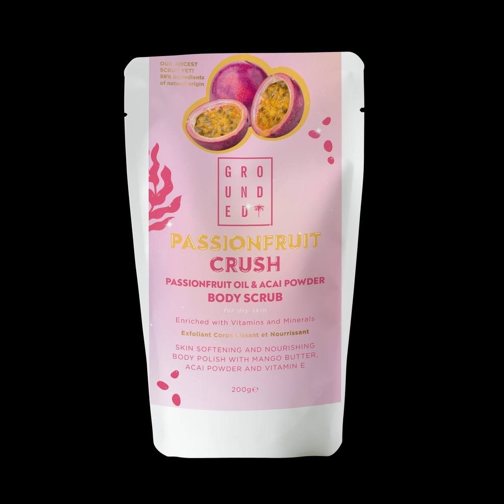 Clear pouch of Grounded Body Passionfruit Crush body scrub, featuring vibrant pink and white design, with passionfruit and acai powder highlighted, 200g size, emphasizing natural ingredients.