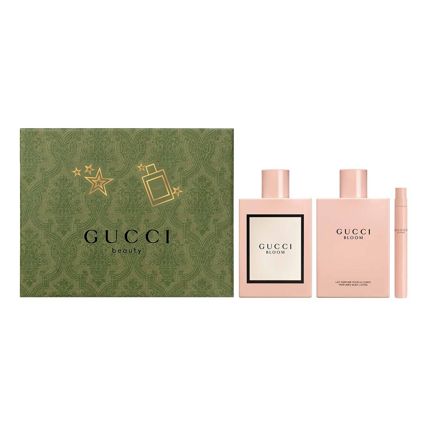 Gucci Bloom gift set featuring two pink bottles with black labels and a pink travel spray, all presented in a green decorative box with gold star accents.