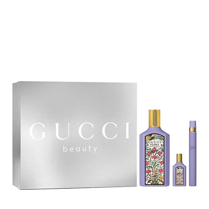 Silver gift box featuring "Gucci beauty" branding, containing a 100ml floral-patterned bottle of Eau De Parfum and two smaller fragrance items in lavender packaging.