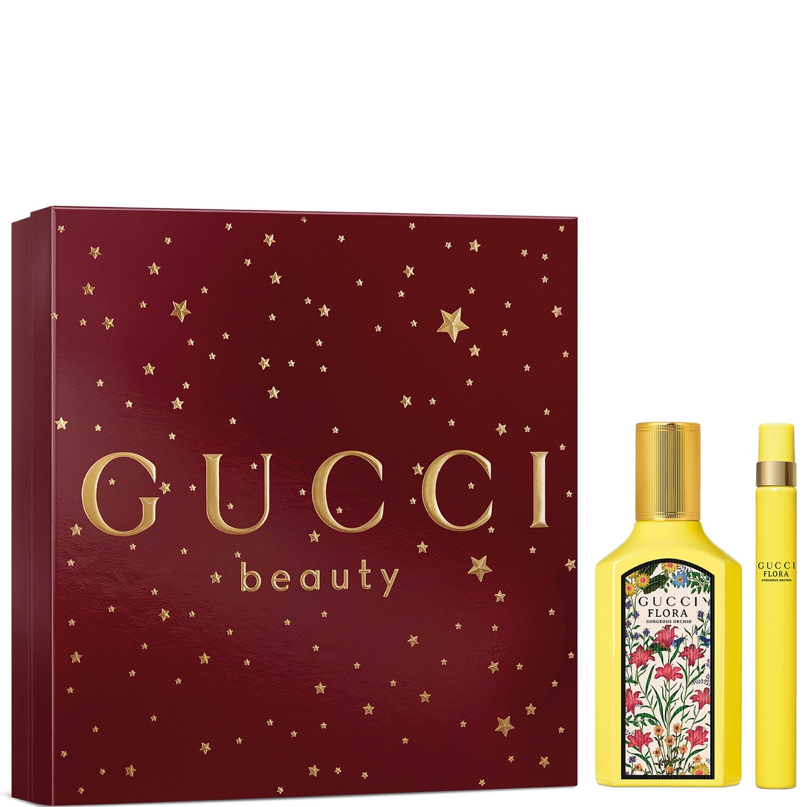 Red gift box with gold stars, featuring "GUCCI beauty" in bold letters, contains a 50ml yellow bottle of Flora Gorgeous Orchid Eau De Parfum and a mini fragrance spray.