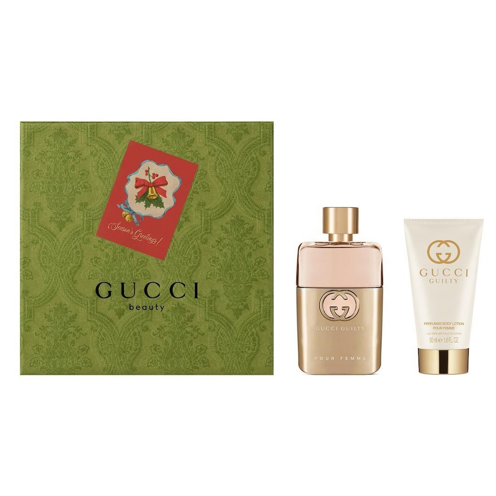 Gucci Guilty Pour Femme gift set features a gold-accented perfume bottle and a matching body lotion, presented in an ornate green box with a festive card.