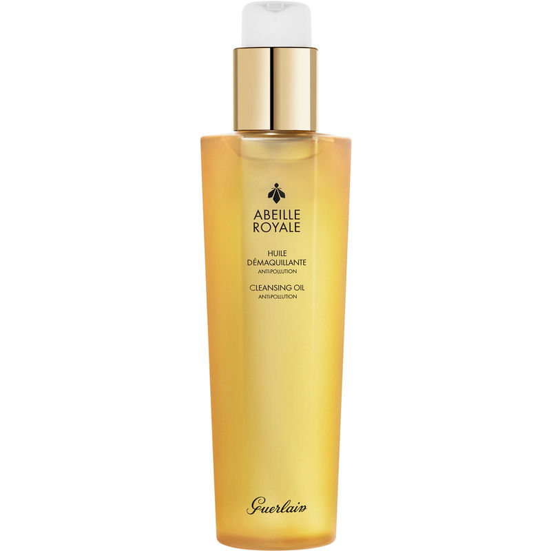 Guerlain Abeille Royale Anti-Pollution Cleansing Oil in a transparent beige bottle with a gold pump, featuring elegant branding and a sleek design.