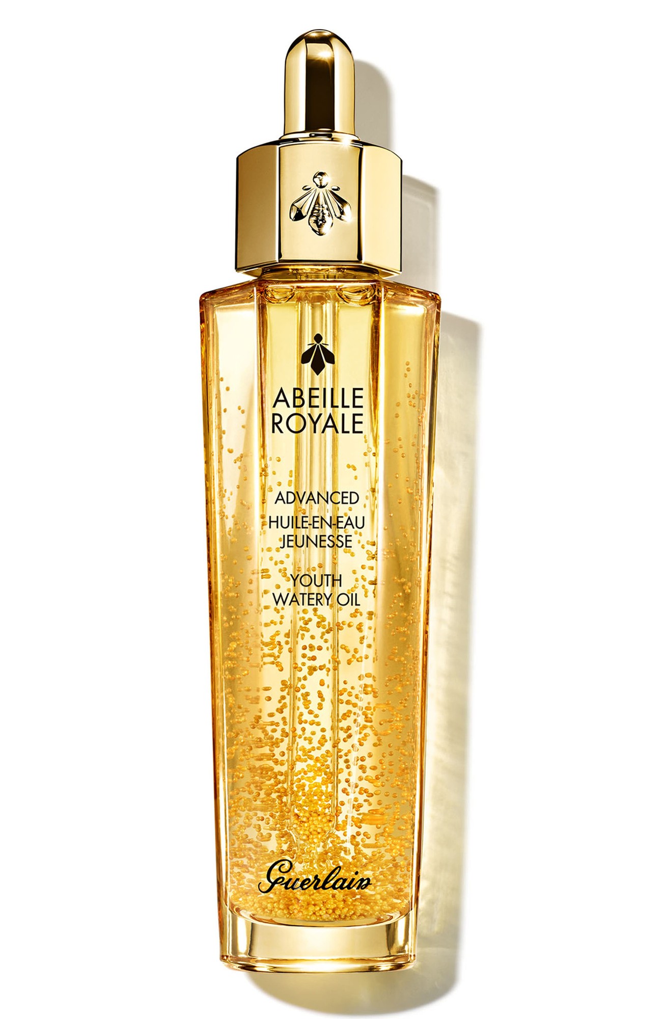 Golden bottle with a sleek design, featuring a dropper cap and the Guerlain logo, containing a shimmering yellow oil with visible golden particles.