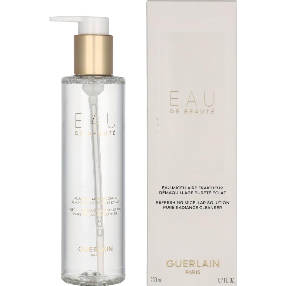 Clear glass bottle with a gold pump and cap, labeled "Eau De Beauté" in elegant font; accompanied by a white box with gold accents, both showcasing a luxurious design.