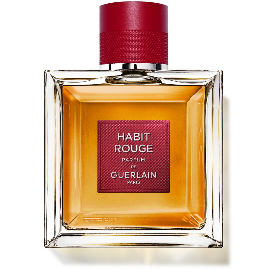 Clear glass bottle with a square shape, featuring a red cap and a red label that reads "Habit Rouge Parfum de Guerlain," containing amber-colored perfume.