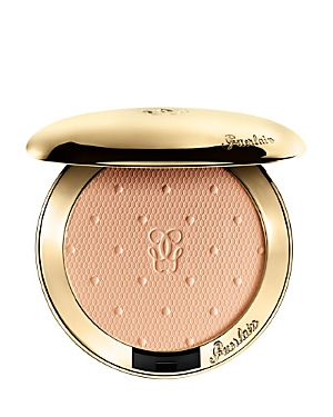 Translucent compact powder in a gold case with a textured peach surface, featuring the Guerlain logo embossed on top, 6.5g size.