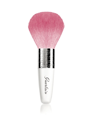 Guerlain Meteorites Powder Brush features a fluffy pink bristle head with a sleek white handle adorned with a silver band and the Guerlain logo.