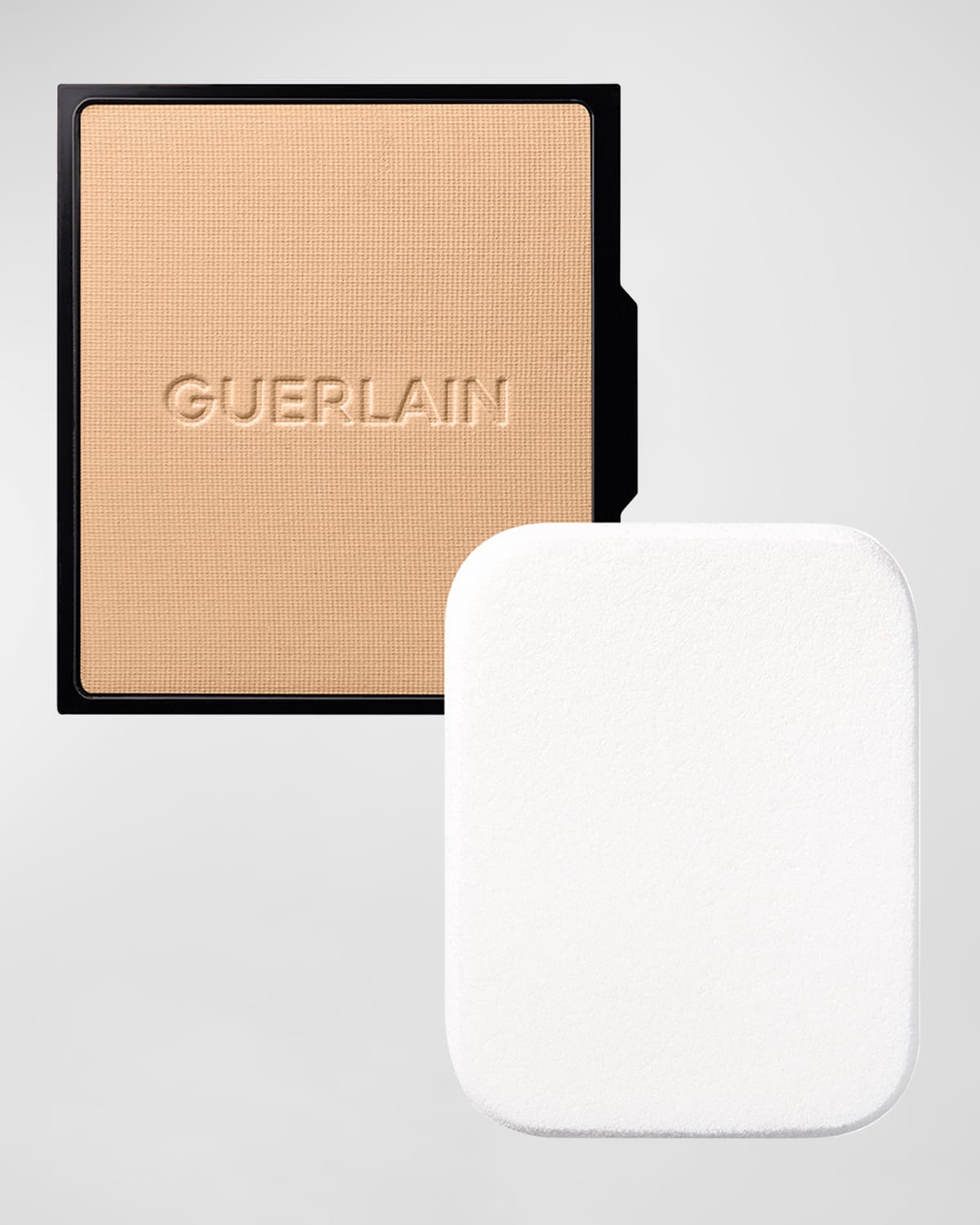 Guerlain Parure Gold Skin Control Mattifying Compact Foundation refill in color 3N Neutral, featuring a smooth, beige powder with the brand name embossed, accompanied by a white applicator sponge.