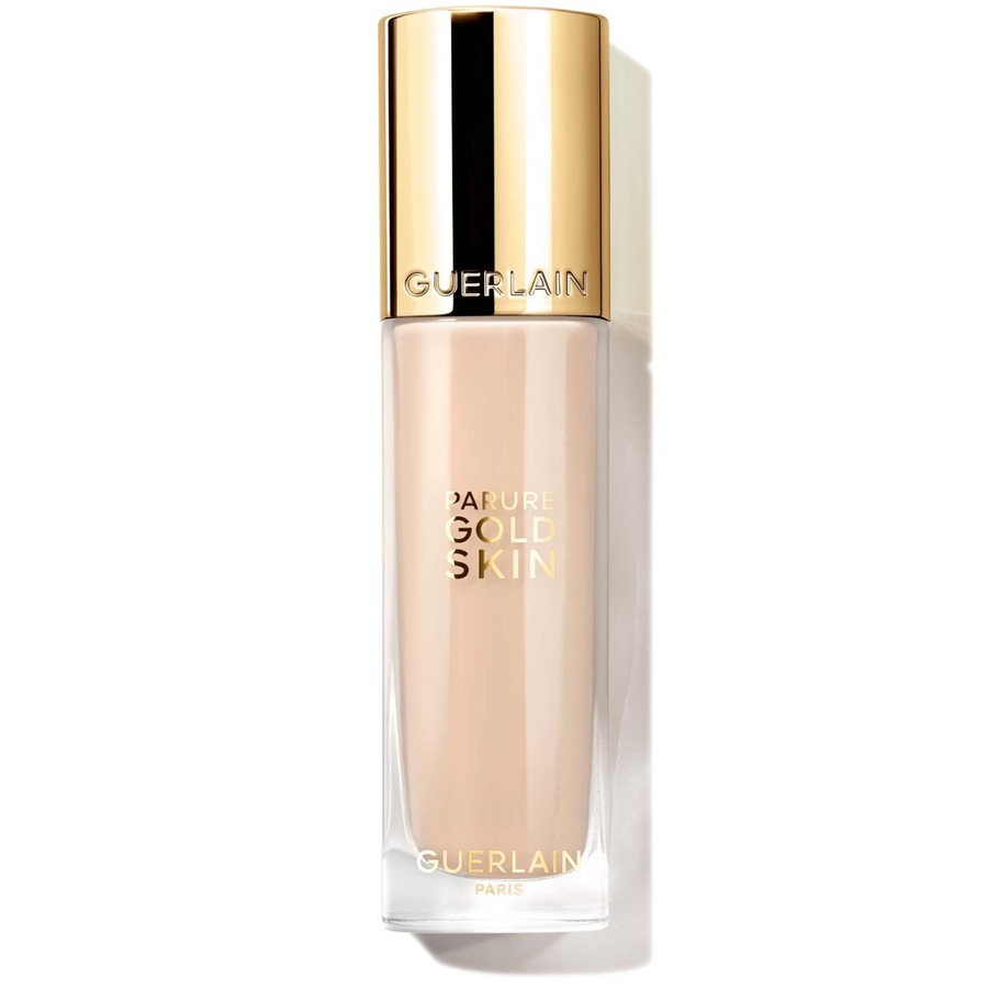 Clear glass bottle with a gold cap, featuring "GUERLAIN" and "Parure Gold Skin" labels, containing a neutral shade foundation, 35ml, designed for skin rejuvenation and radiance.