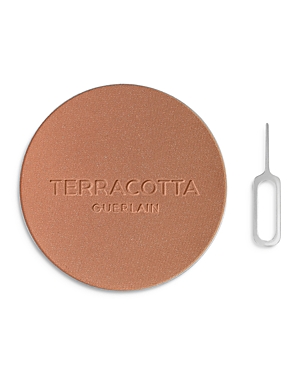 Round terracotta bronzer refill in warm bronze shade with a smooth finish, embossed with "TERRACOTTA GUERLAIN," accompanied by a small metal tool for easy removal.
