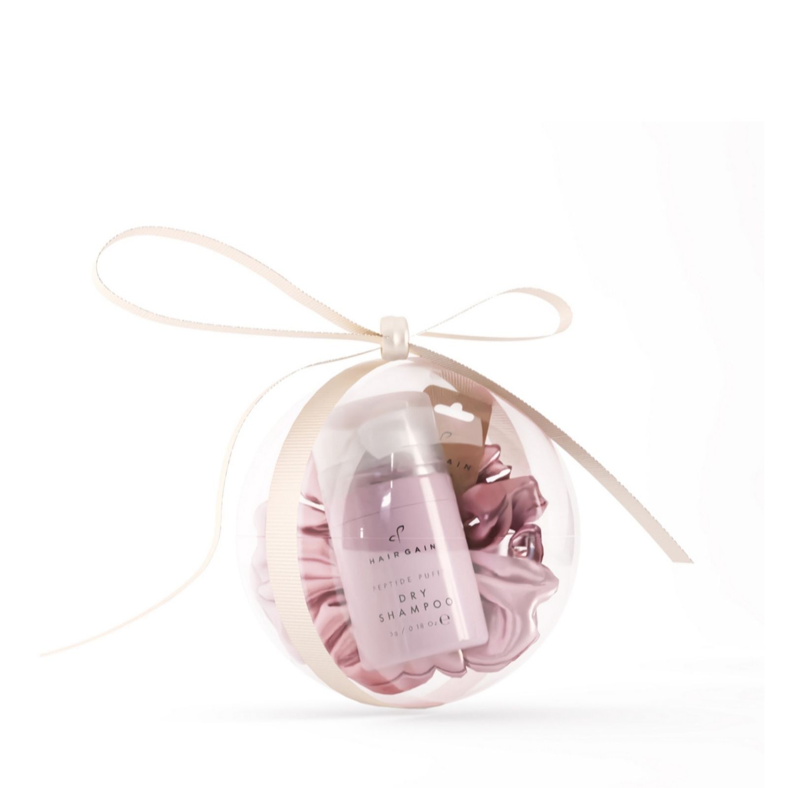 Clear bauble containing a pink dry shampoo bottle and a matching scrunchie, elegantly tied with a cream ribbon.