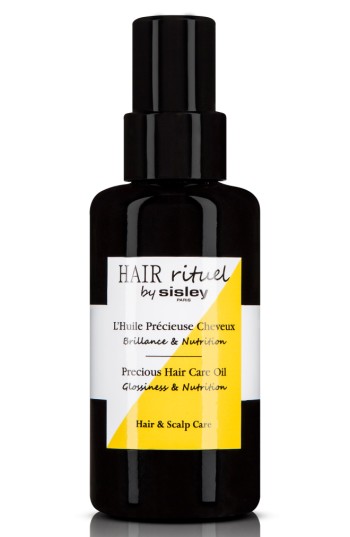 Black glass bottle with a pump dispenser, labeled "Hair Rituel by Sisley," featuring yellow accents and text highlighting "Precious Hair Care Oil Glossiness & Nutrition."