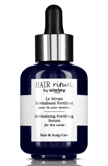 Navy blue glass bottle with a dropper, featuring a white label that reads "Hair Rituel by Sisley" and "Revitalizing Fortifying Serum for the scalp" in black text.