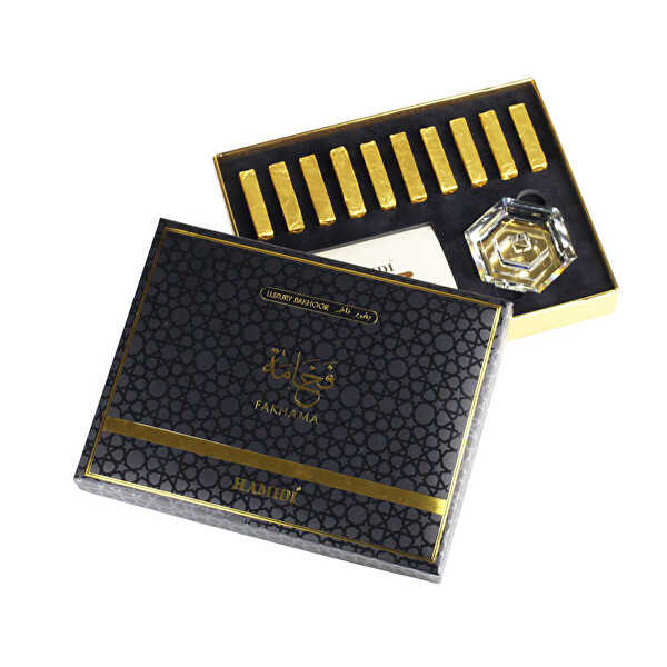 Elegant black box with gold accents, containing Fakhama Bakhoor sticks, a glass holder, and a card, all set against a plush black interior.
