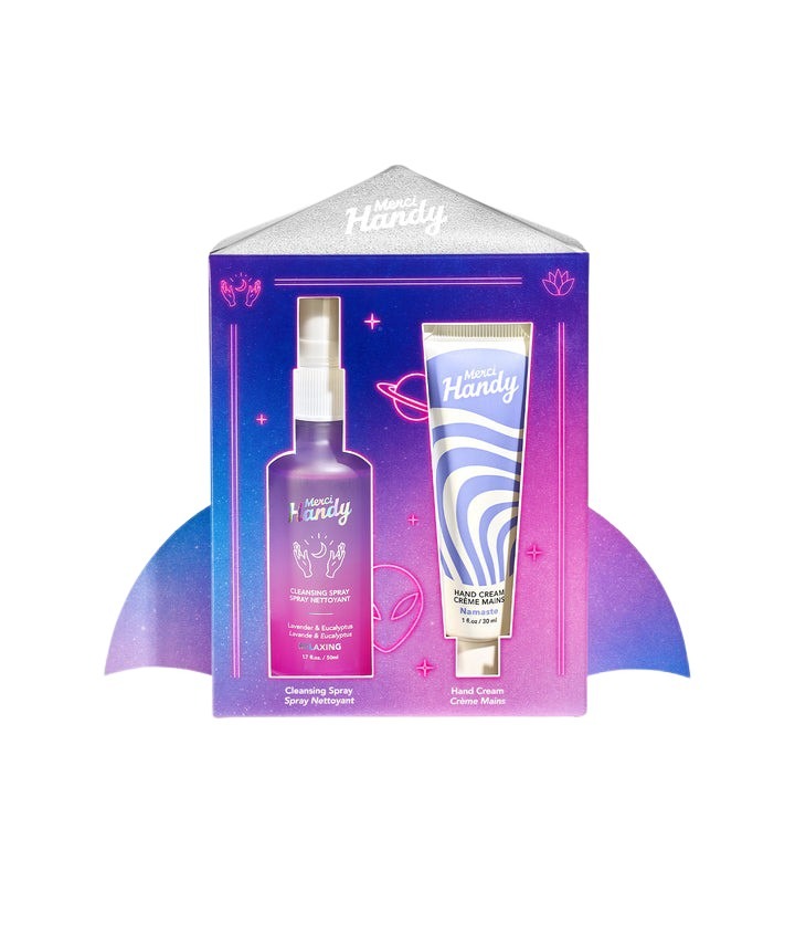 Purple and blue packaging featuring a cleansing spray and hand cream, with whimsical graphics and a cosmic theme, showcasing the Merci Handy brand.