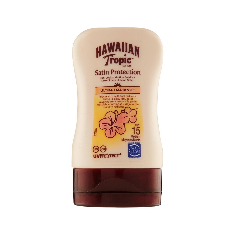 Hawaiian Tropic Glowing Mini Protective Tanning Cream SPF 15 in a beige bottle with a floral design, featuring a flip-top cap and a glossy finish, 100 ml size.