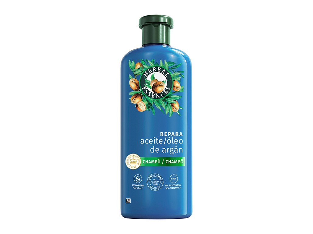 Green and blue bottle of Herbal Essences shampoo, featuring argan oil, with a label that reads "Repara" and "Champô" in bold, surrounded by illustrations of argan nuts and leaves.