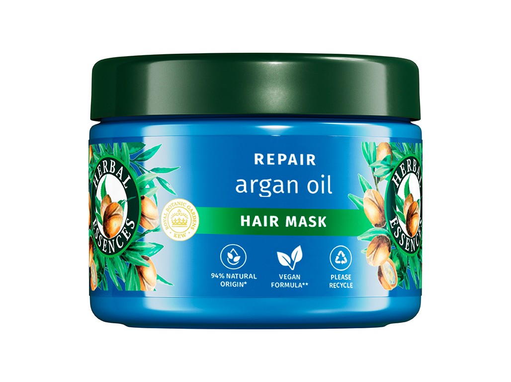 Bright blue jar with a green lid, featuring a design of argan nuts and leaves, labeled "Repair Argan Oil Hair Mask" by Herbal Essences, 500ml, with vegan and recyclable symbols.