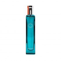 Clear glass bottle with a rectangular shape, featuring a silver cap and an orange accent, containing Eau D Orange Verte by Hermès, a vibrant turquoise liquid.