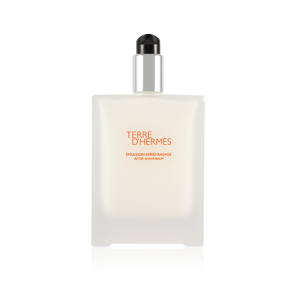 Clear glass bottle with a sleek design, featuring a black pump top and an orange label that reads "TERRE D'HERMÈS ÉMULSION APRÈS-RASAGE AFTER-SHAVE BALM."