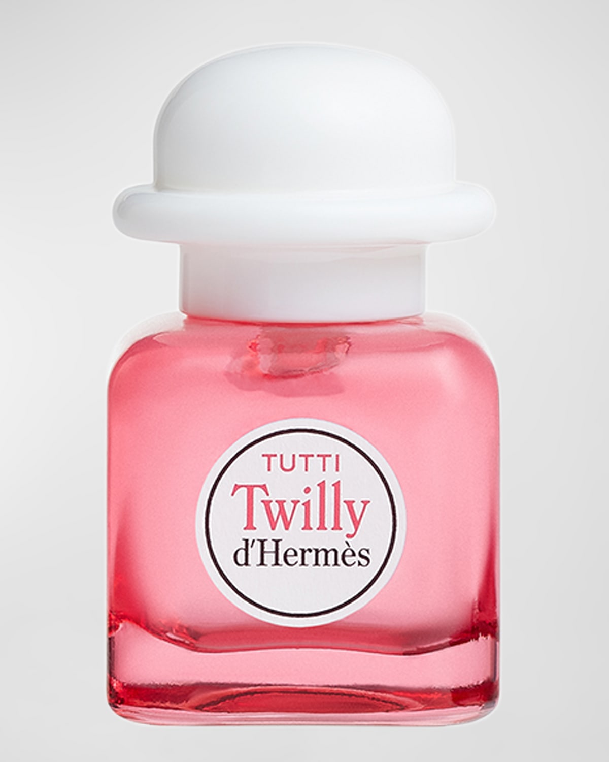 Small pink glass bottle of Tutti Twilly d'Hermès Eau De Parfum with a white cap, featuring a round label with red text on the front.