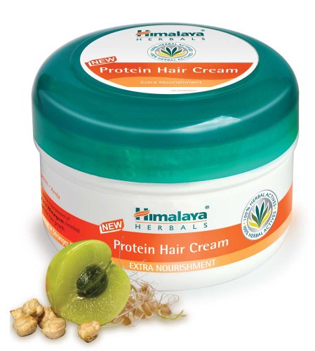 Green and white round container of Himalaya Herbals Protein Hair Cream, featuring a turquoise lid, with ingredients like amla and herbs displayed beside it.