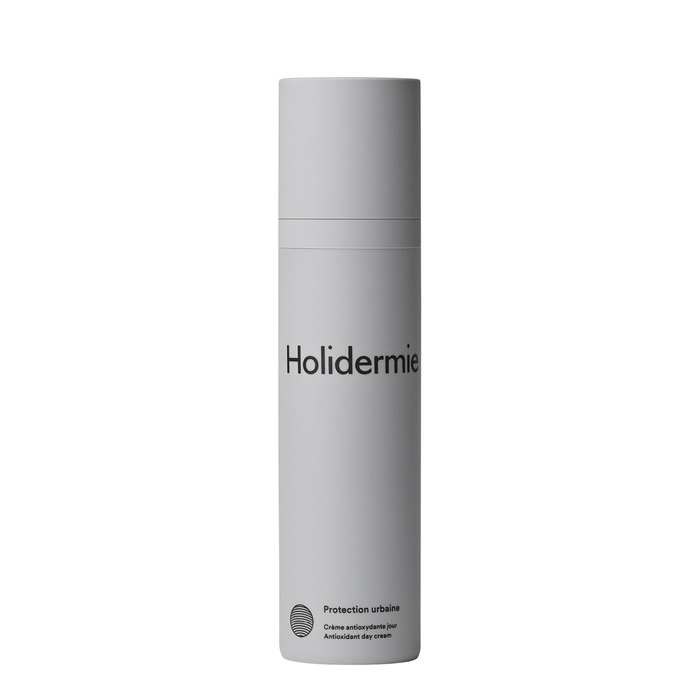 Gray cylindrical bottle with a matte finish, featuring the brand name "Holidermie" in bold black text and "Protection urbaine" label, designed for antioxidant skincare.