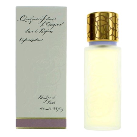 Clear glass bottle of Debenhams Quelques Fleurs L'original Eau De Parfum with a gold ornate cap, alongside a pale green box featuring elegant script, both labeled Houbigant, Paris.