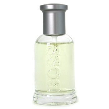 Clear glass bottle with a silver cap, featuring the embossed "BOSS" logo, accompanied by a matching shower gel and deodorant spray in sleek packaging.