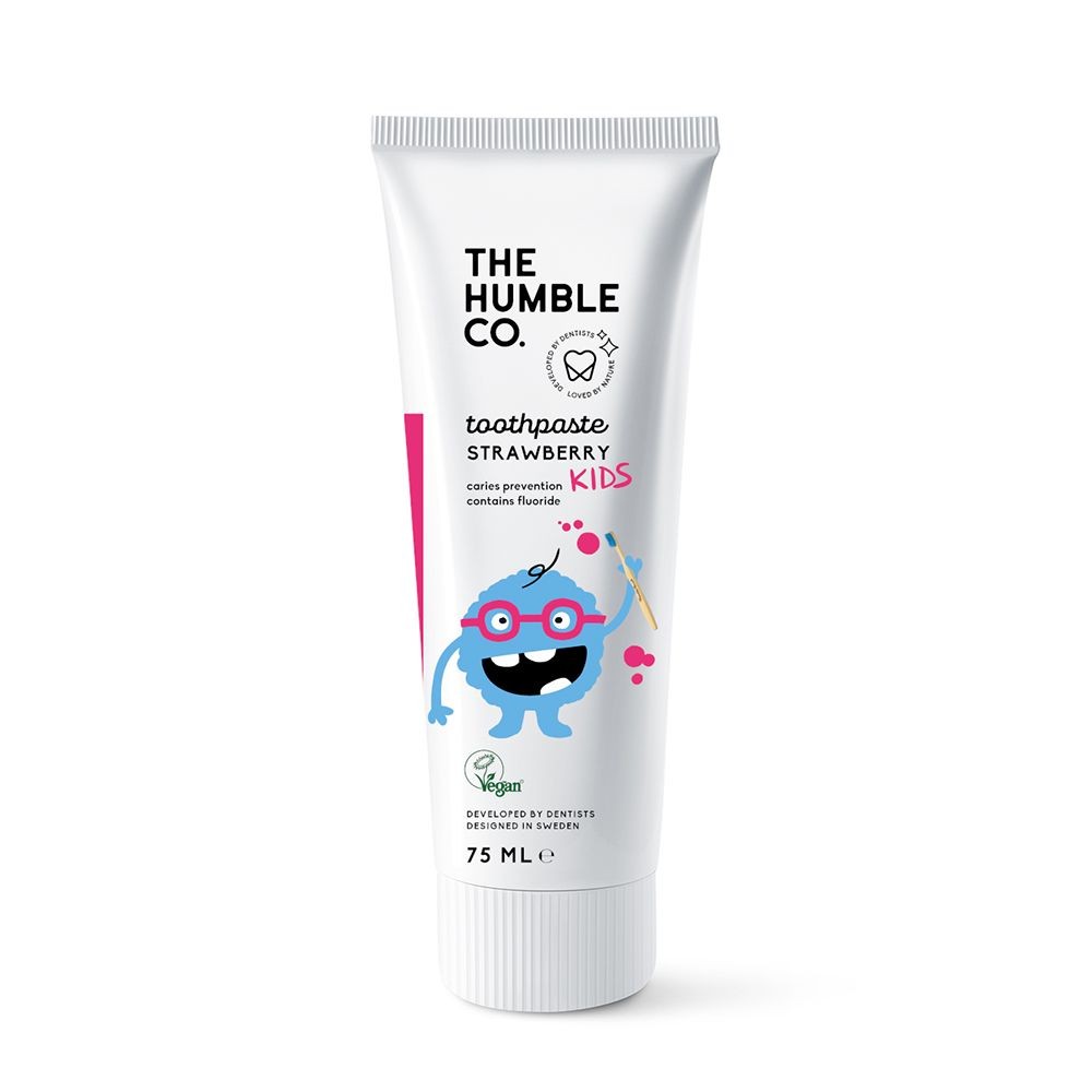 White tube of The Humble Co. Kids Toothpaste in Strawberry flavor, featuring a colorful cartoon character, with a pink accent and 75ml capacity, highlighting its vegan and fluoride content.