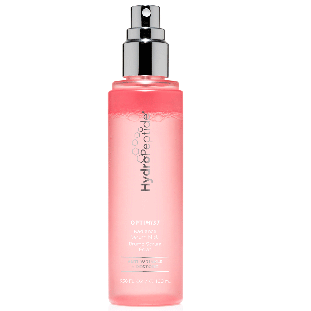 HydroPeptide Optimist Radiance Serum Mist in a clear pink bottle with a silver spray nozzle, labeled with product details and featuring a brightening formula with Vitamin C.