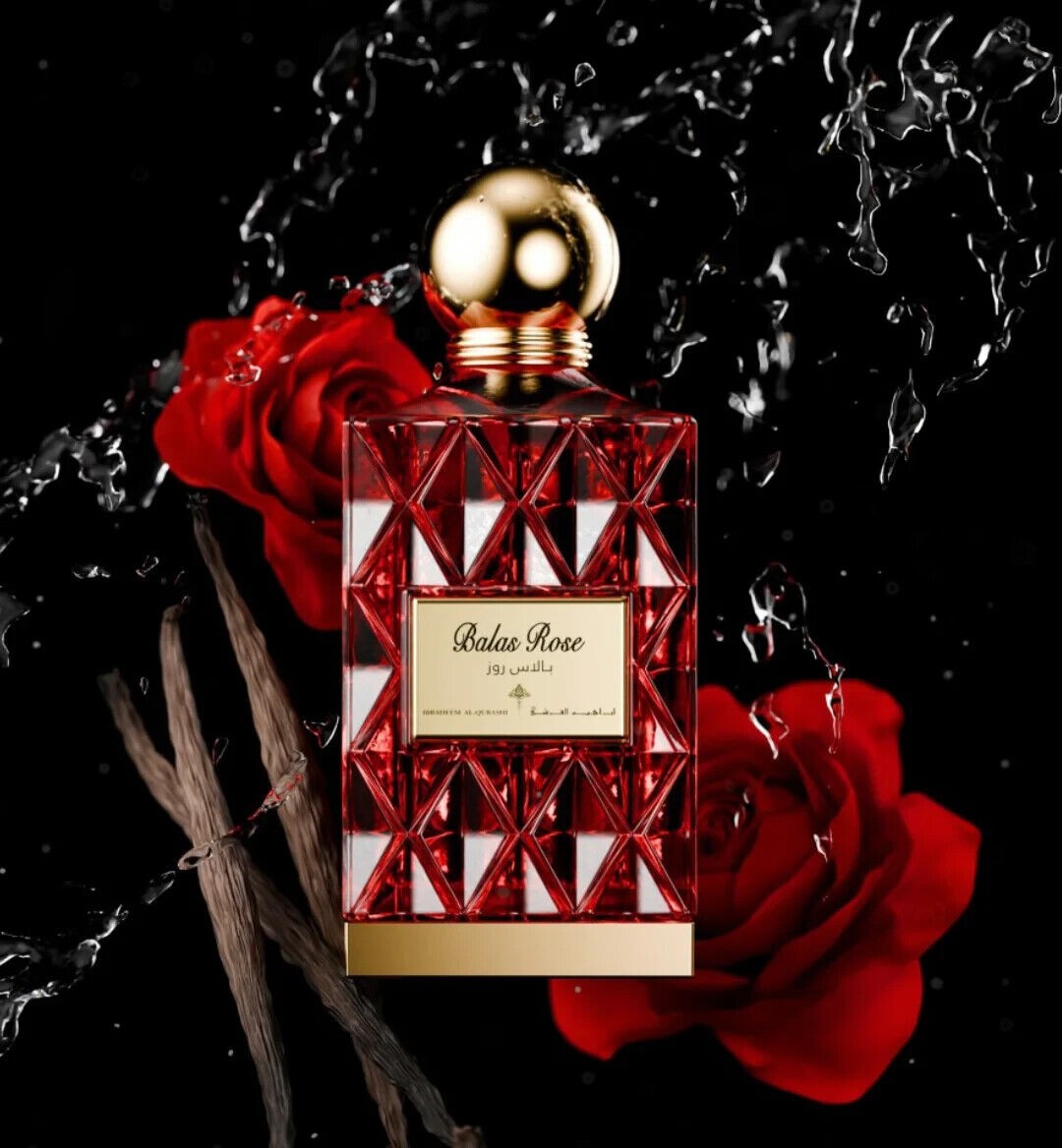 Balas Rose perfume features a striking red glass bottle with a geometric design, topped with a gold cap, surrounded by red roses and splashes of water.