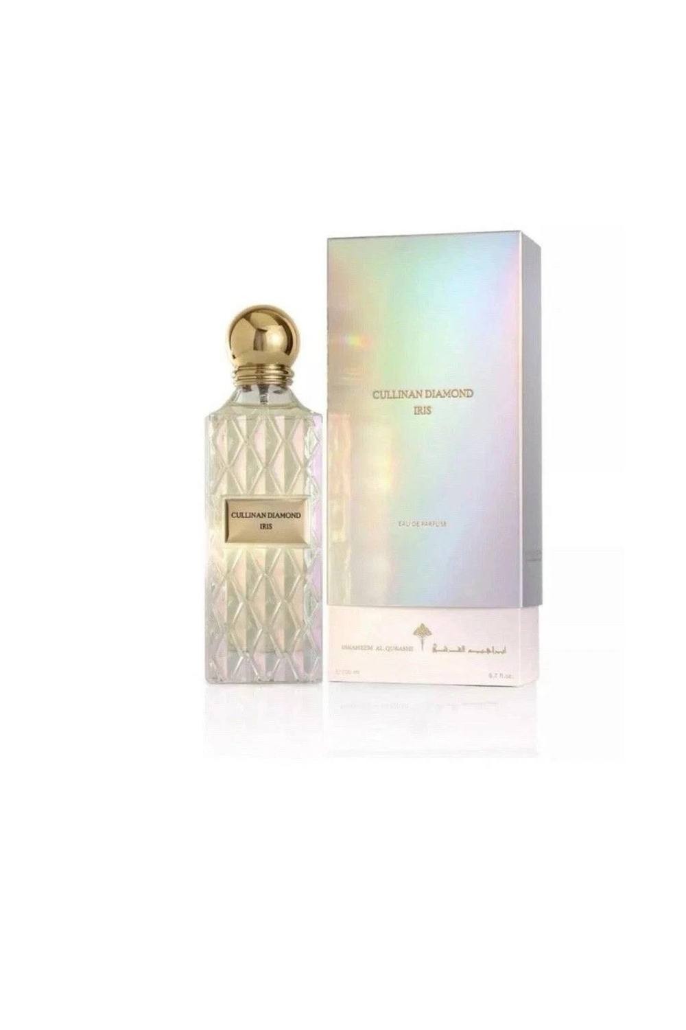 Cullinan Diamond Iris Eau De Parfum in a faceted glass bottle with a gold cap, accompanied by an iridescent box, both showcasing elegant design elements.