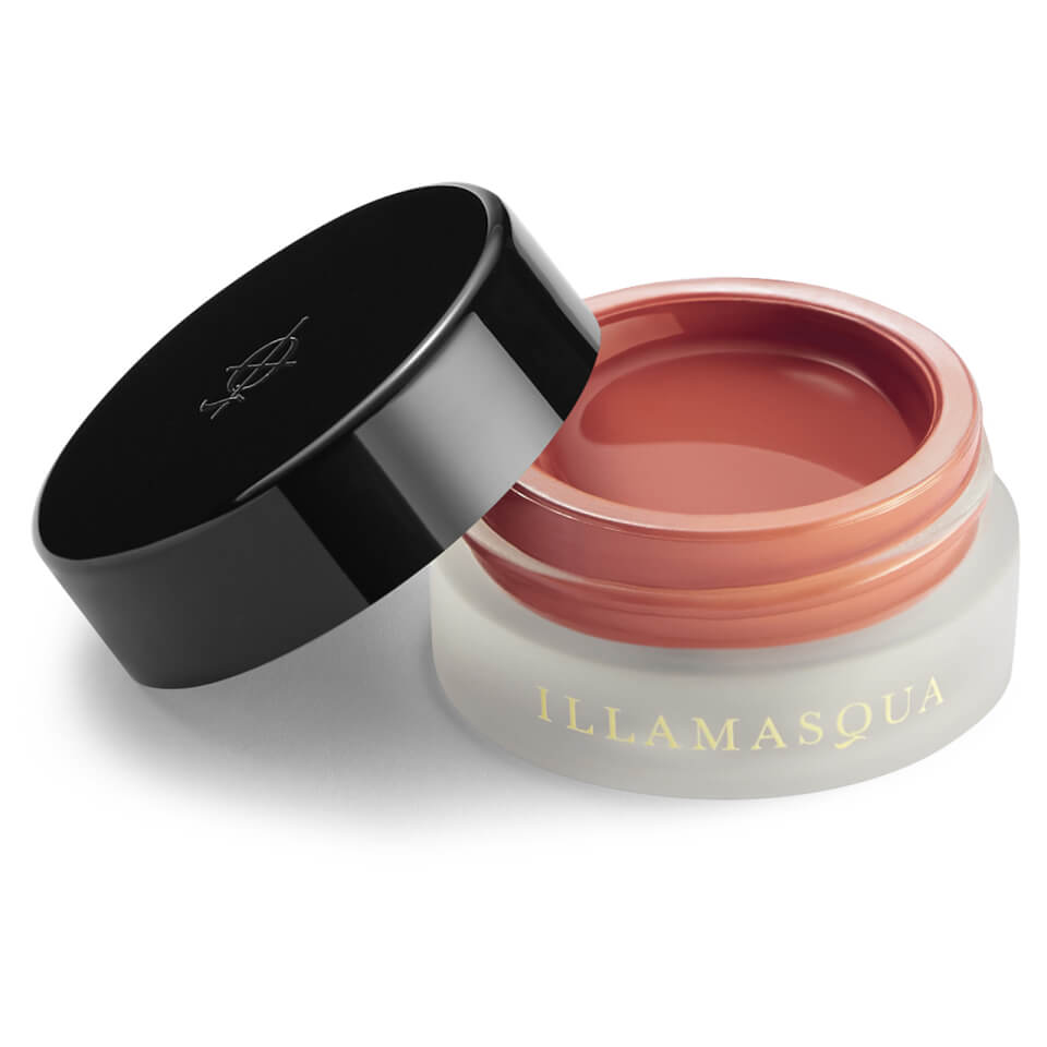 Illamasqua Colour Veil in the shade "Entice," featuring a sleek black lid and a transparent jar, showcasing a creamy, soft peach-toned product inside.