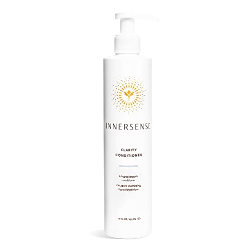 White bottle with a pump dispenser, featuring a gold sunburst logo and "Innersense Clarity Hairbath Shampoo" text, labeled as fragrance-free for all hair types, 295ml.