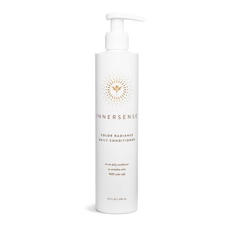 White bottle with a pump top featuring a gold logo and text, labeled "Innersense Color Radiance Daily Conditioner," designed for color and chemically treated hair, 295ml.