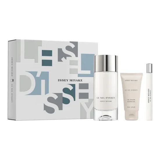 Gift set featuring Issey Miyake Le Sel D'Issey fragrance in a sleek glass bottle, accompanied by a travel-size spray and a cream, all presented in a stylish blue and gray box.