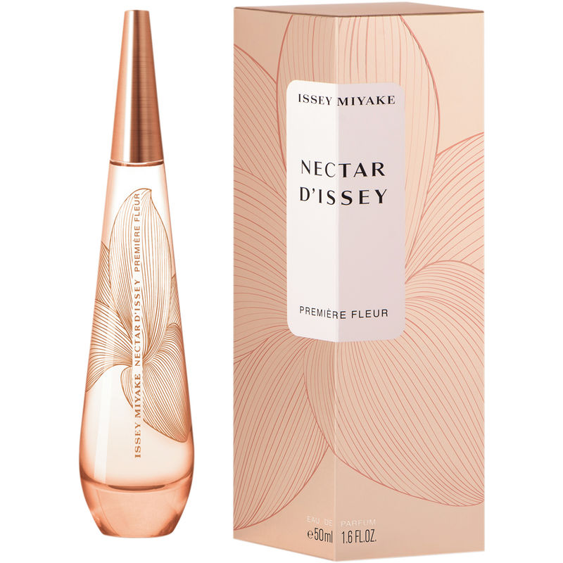 Elegant glass bottle with a tapered design, featuring a soft pink hue, alongside a matching box adorned with floral patterns in pastel tones.