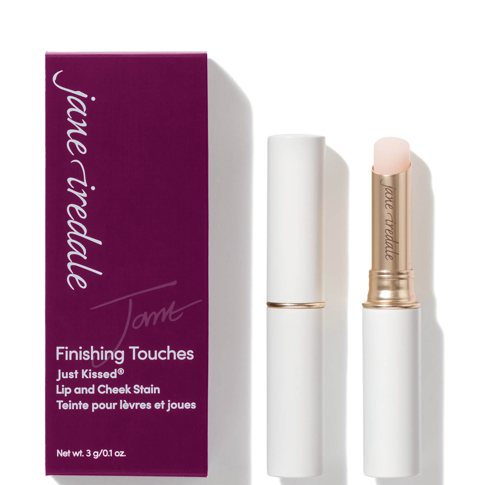 A white tube with a gold accent holds a clear lip and cheek stain, accompanied by a purple box labeled "Jane Iredale Just Kissed Lip and Cheek Stain - Forever You."