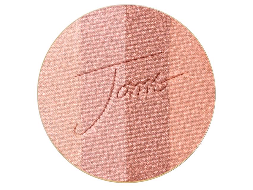 Round bronzer refill in soft peach and cream shades, featuring a textured surface with the "Jane" logo embossed, housed in a sleek, gold-toned compact.
