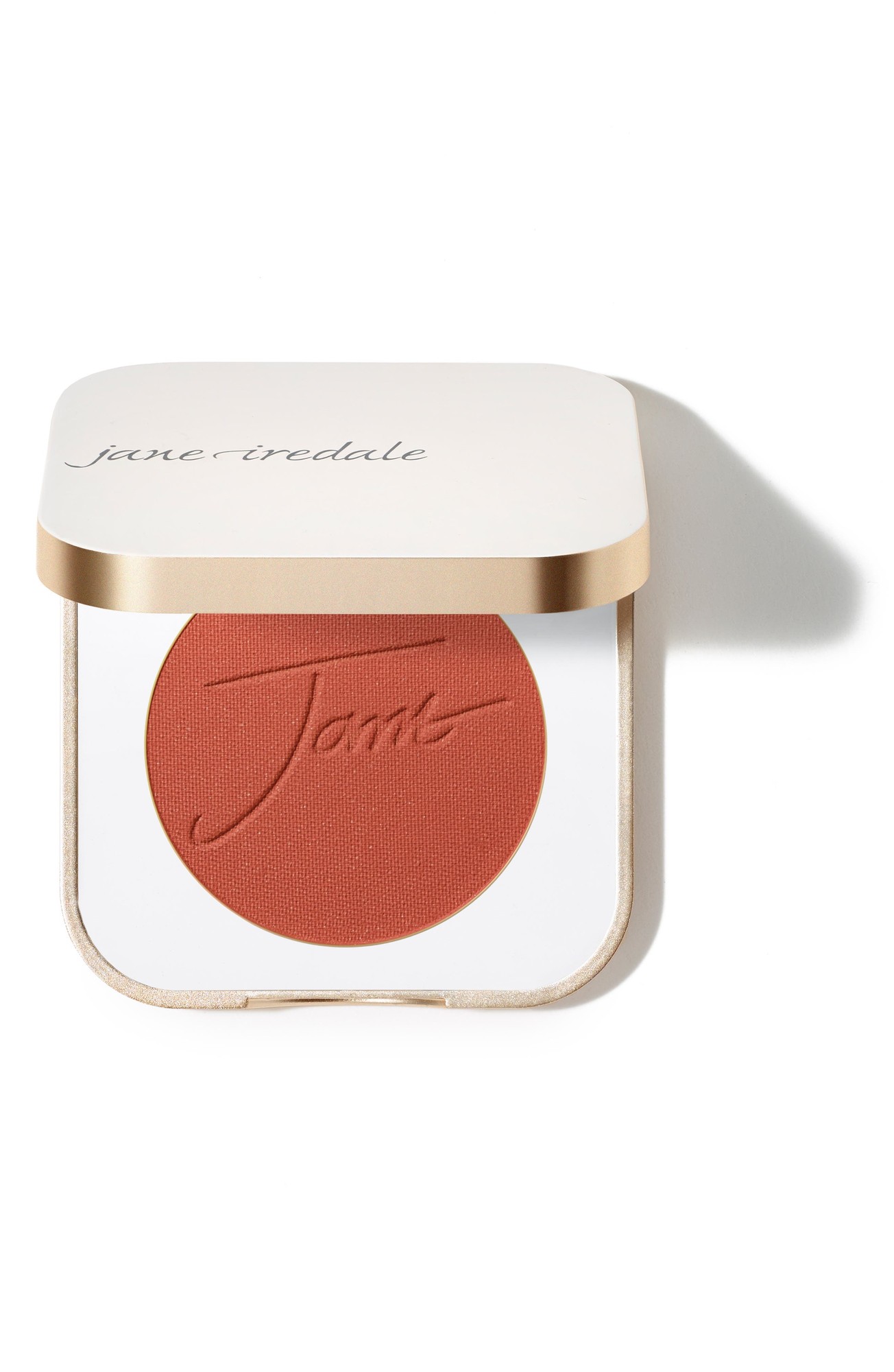 Pure Pressed Blush in "Sunset" by Jane Iredale, featuring a warm, matte terracotta shade in a sleek, gold-trimmed compact with embossed logo on the blush surface.