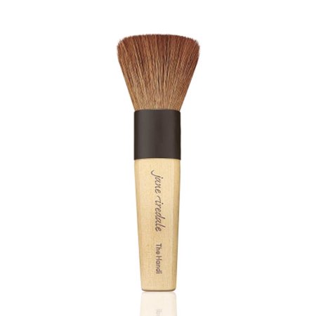 A makeup brush with a bamboo handle, black ferrule, and soft, dense bristles, designed for applying mineral makeup evenly.