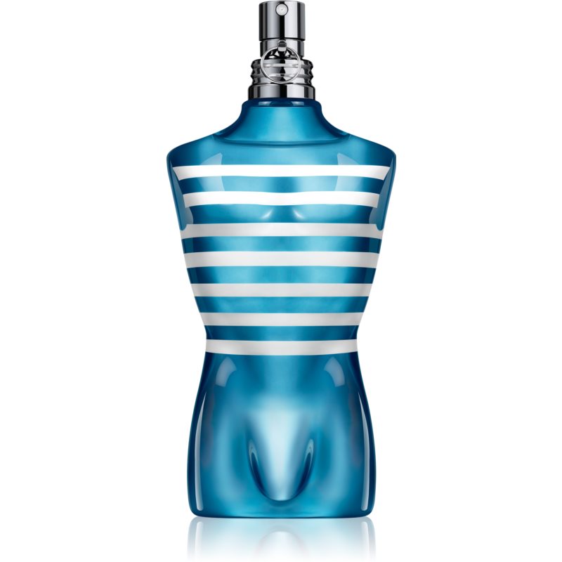 A blue glass bottle shaped like a male torso, featuring white horizontal stripes, topped with a silver spray nozzle, representing Jean Paul Gaultier's Le Male on Board fragrance.