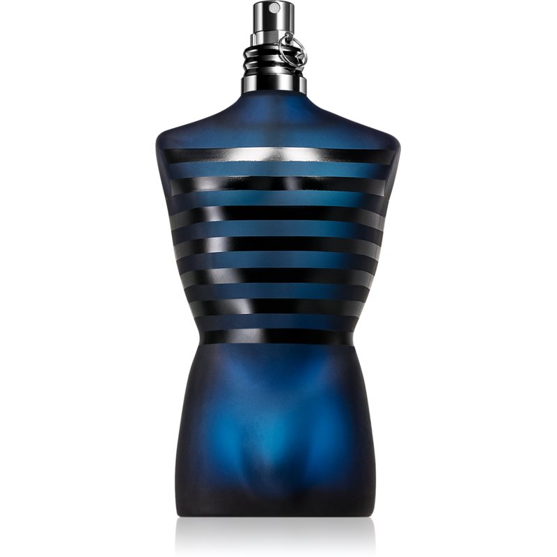 Dark blue bottle shaped like a male torso, featuring black horizontal stripes and a metallic spray nozzle, representing Jean Paul Gaultier's Ultra Male Eau De Toilette Intense.