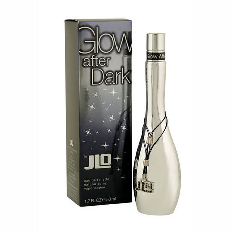 Silver, sleek perfume bottle with a curved shape and a black cord featuring charms, alongside a black box adorned with silver stars and the text "Glow After Dark by JLO."